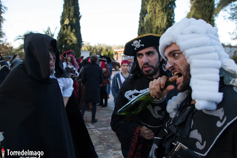 Un hombre caracterizado de pirata saca el corcho de una botella con los dientes.