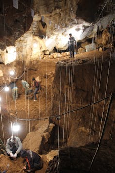 A photo of archaeologists at work in a cave.