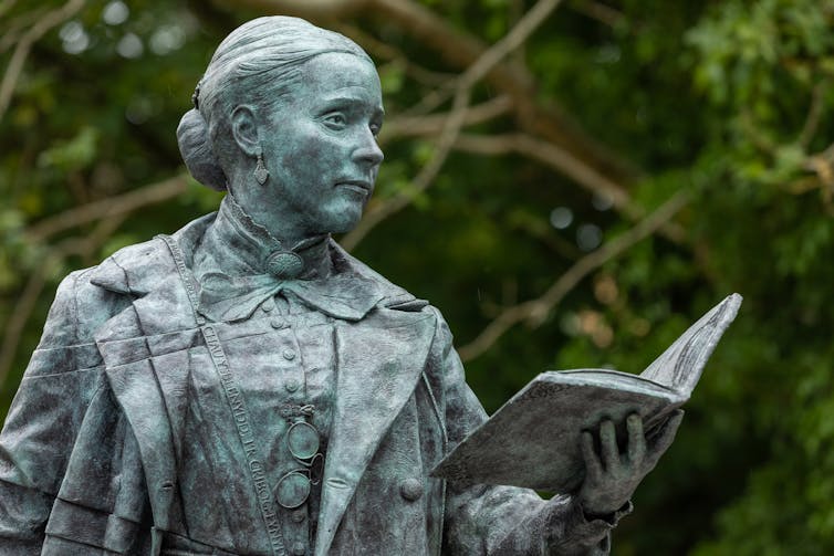 A statue of a woman reading a book