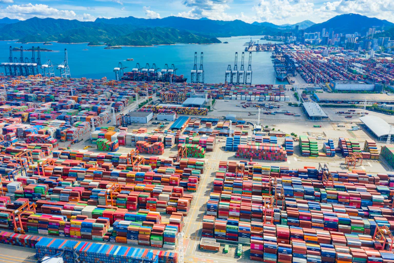 A huge shipping port in China with shipping containers as far as the eye can see.