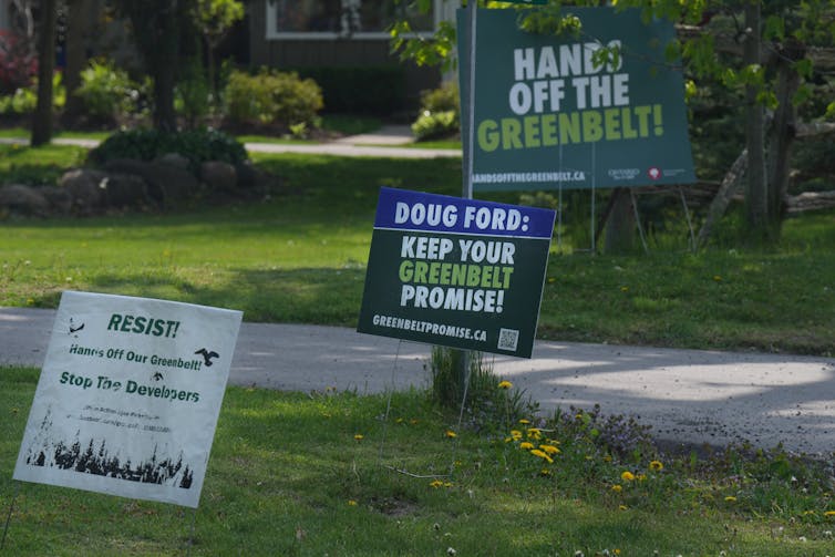 Signs urge Doug Ford to keep his hands off the Greenbelt.