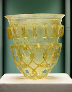 A decorative, yellowish glass cup.