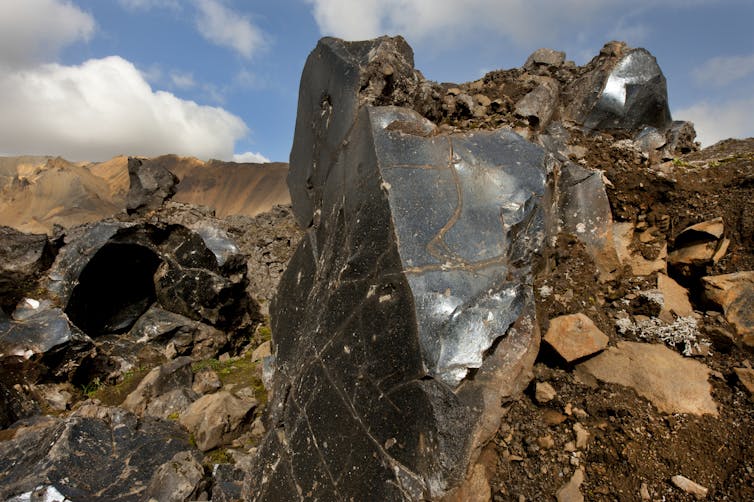 A large block of shiny black stone.