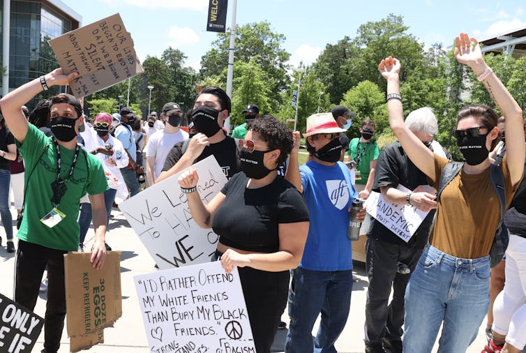 People standing at a rally.