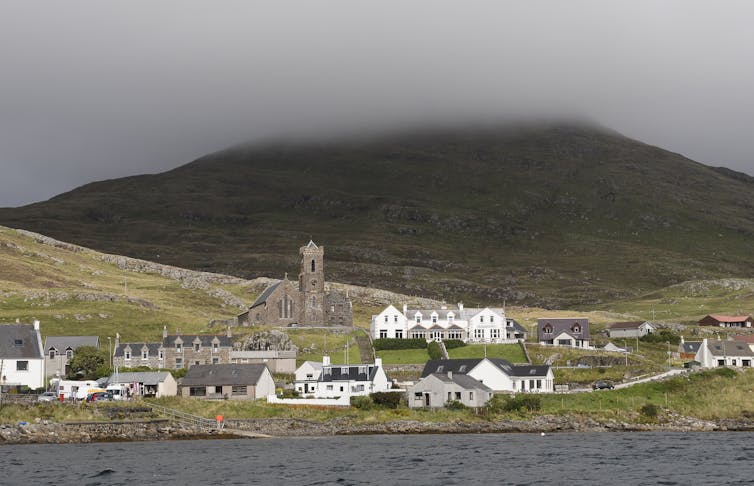 Cloud descends on a mountain above a small village.
