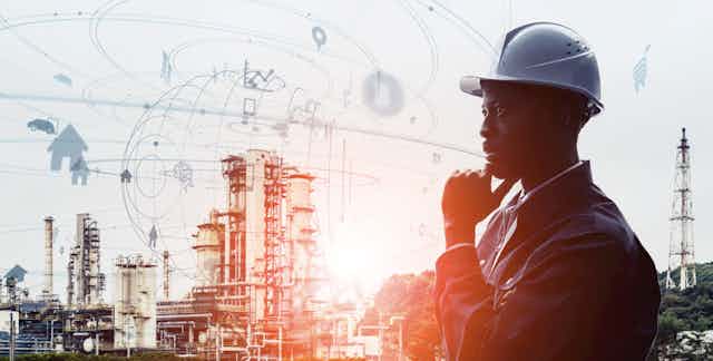 a man in a hard hat gazes into space. there are buildings and scaffolding in the background, and floating images.