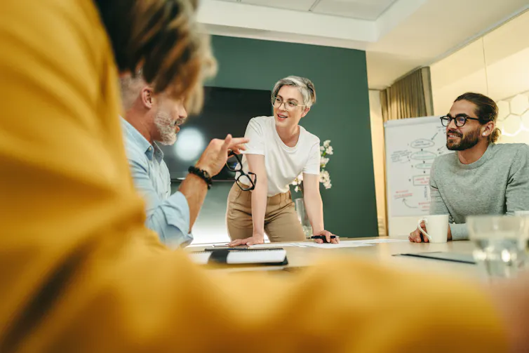 Staff collaborate in meeting room