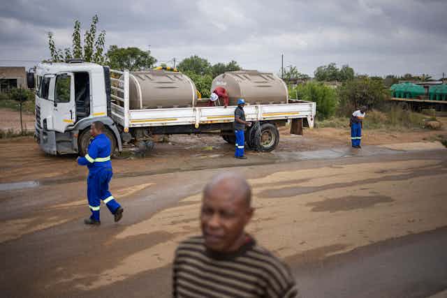 A water tanker parked on the side of the road 