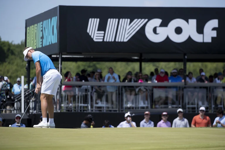 A man plays golf