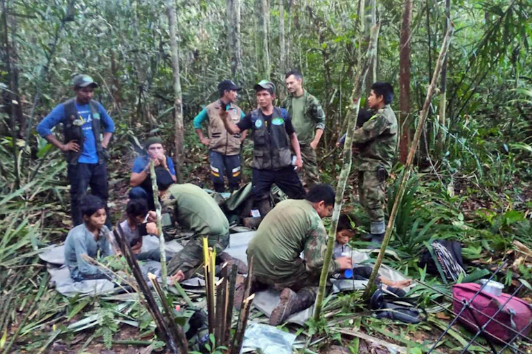 COlombian children and rescuers in deep Amazonian forest in Colombia