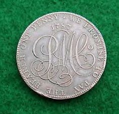 A close up of a silver coin on a green background.