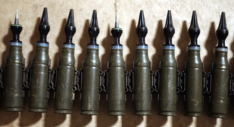 A row of munitions with pointed tips