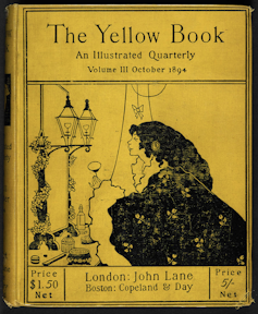 The yellow Cover of The Yellow Book showing a woman in a cloak looking towards a lamp.