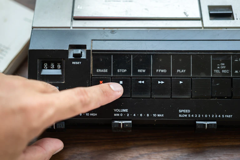 a hand reaches out to touch the stop button on a video player