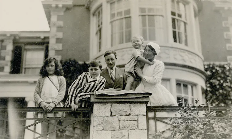 Black and white photograph of Leonora Carrington with her brothers Gerard and Arthur, her uncle George Moorhead and nanny Mary Kavanaugh at Hazelwood Hall.