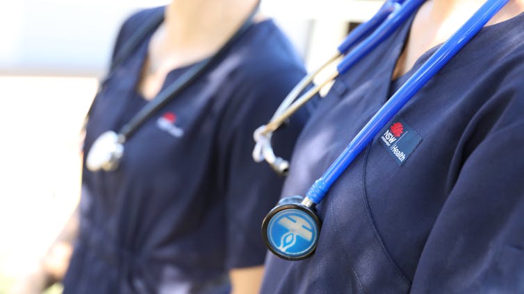 Two nurses with stethoscopes around their necks.