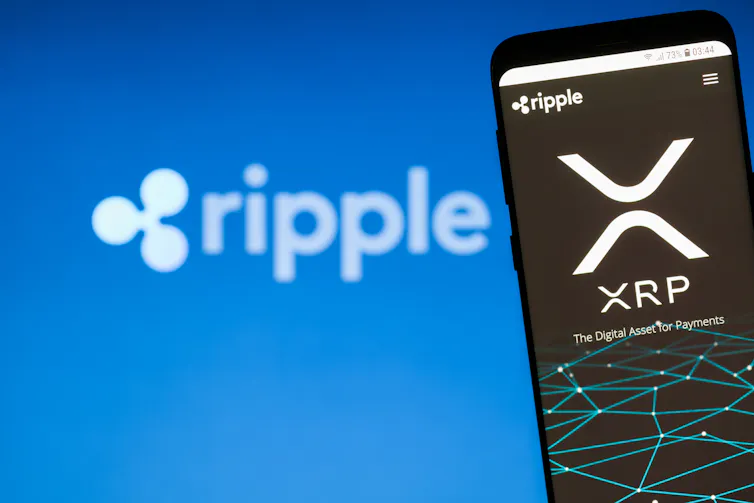 Blue screen with white ripple logo in background, foreground image is a phone that says