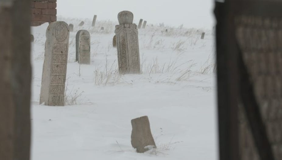 Famine graves in a still from the documentary, set in a snowy scene.