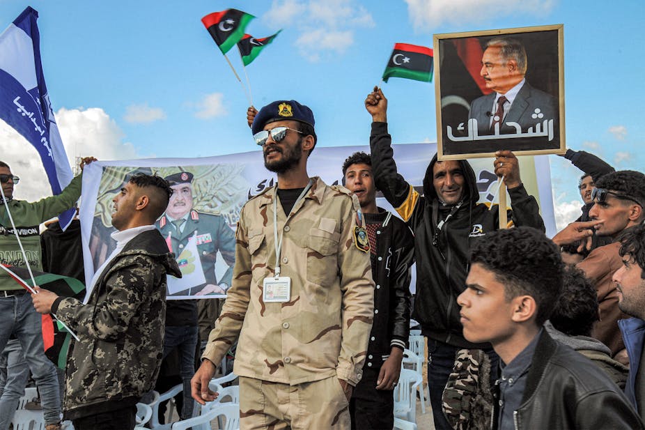 Supporters of Libya's eastern strongman Khalifa Haftar attend a rally marking the 71st anniversary of the country's independence from Italy in the eastern city of Benghazi on December 24, 2022.