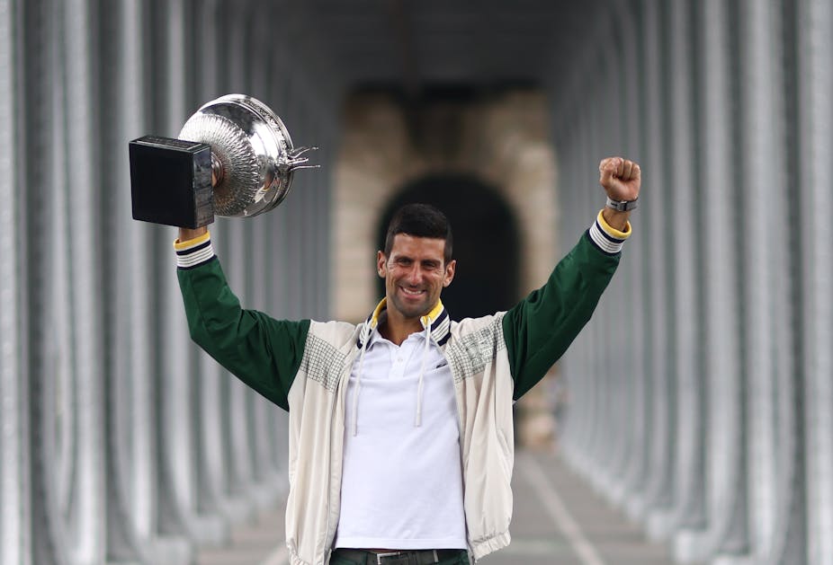 Djokovic lifting the French Open cup aloft.
