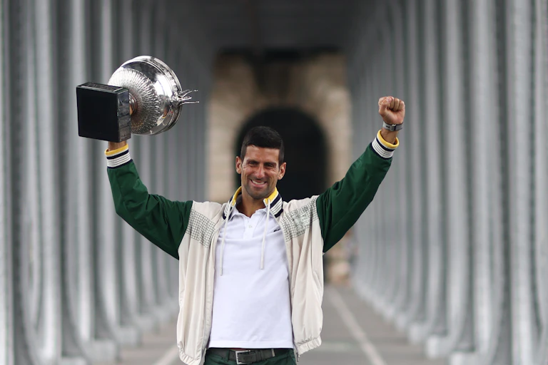 Djokovic lifting the French Open cup aloft.