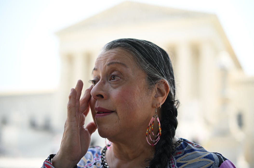 Wiping away tears, Nita Battise, vice chairperson of the tribal council of the Alabama-Coushatta Tribe of Texas, reacts to the Supreme Court ruling upholding a law that gives Native American families priority in adoptions and foster care placements of tribal children