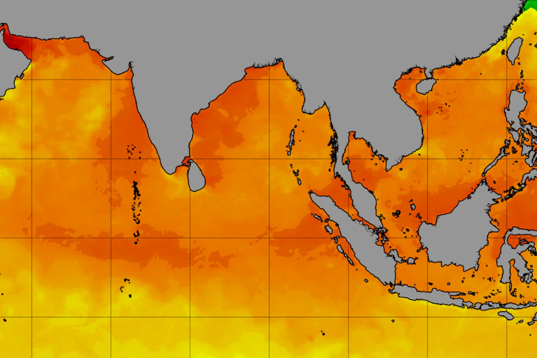 A satellite map colored by sea surface temperature shows high heat across the Indian Ocean and across Southeast Asia.