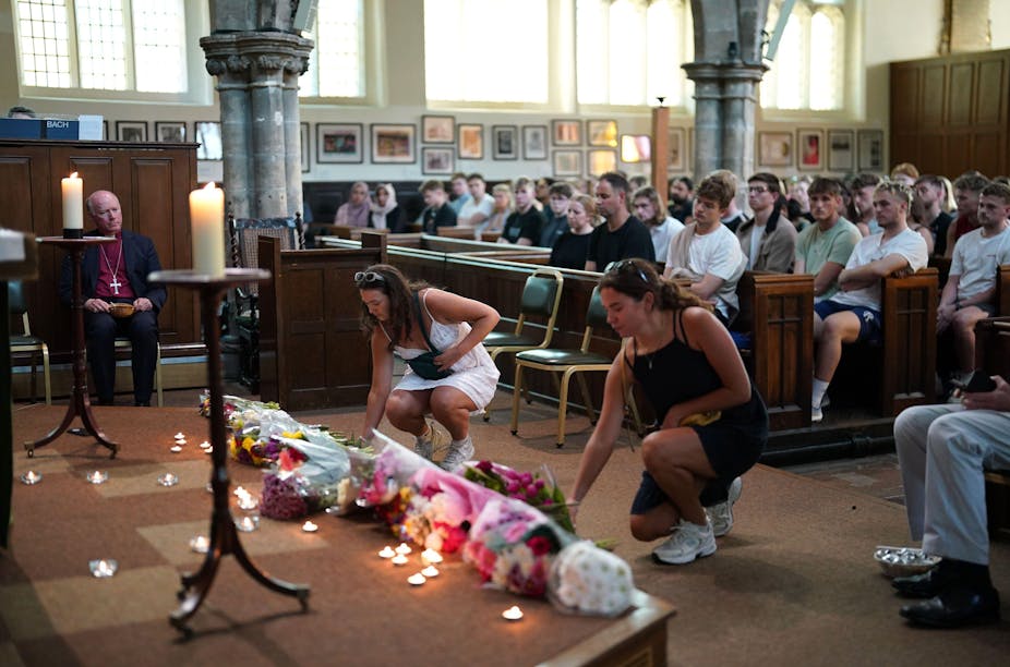 People in a church laying flowers.