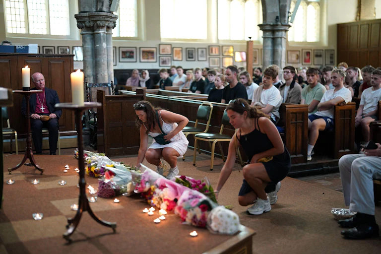People in a church laying flowers.