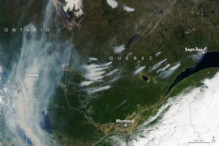 A satellite image showing wildfires burning across Quebec.