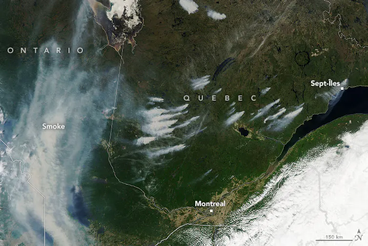 A satellite image showing wildfires burning across Quebec.