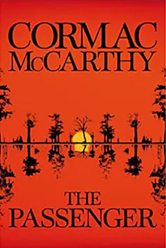 A bright red book cover of Cormac McCarthy's The Passenger
