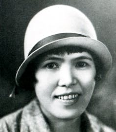 A Japanese woman in a white hat.