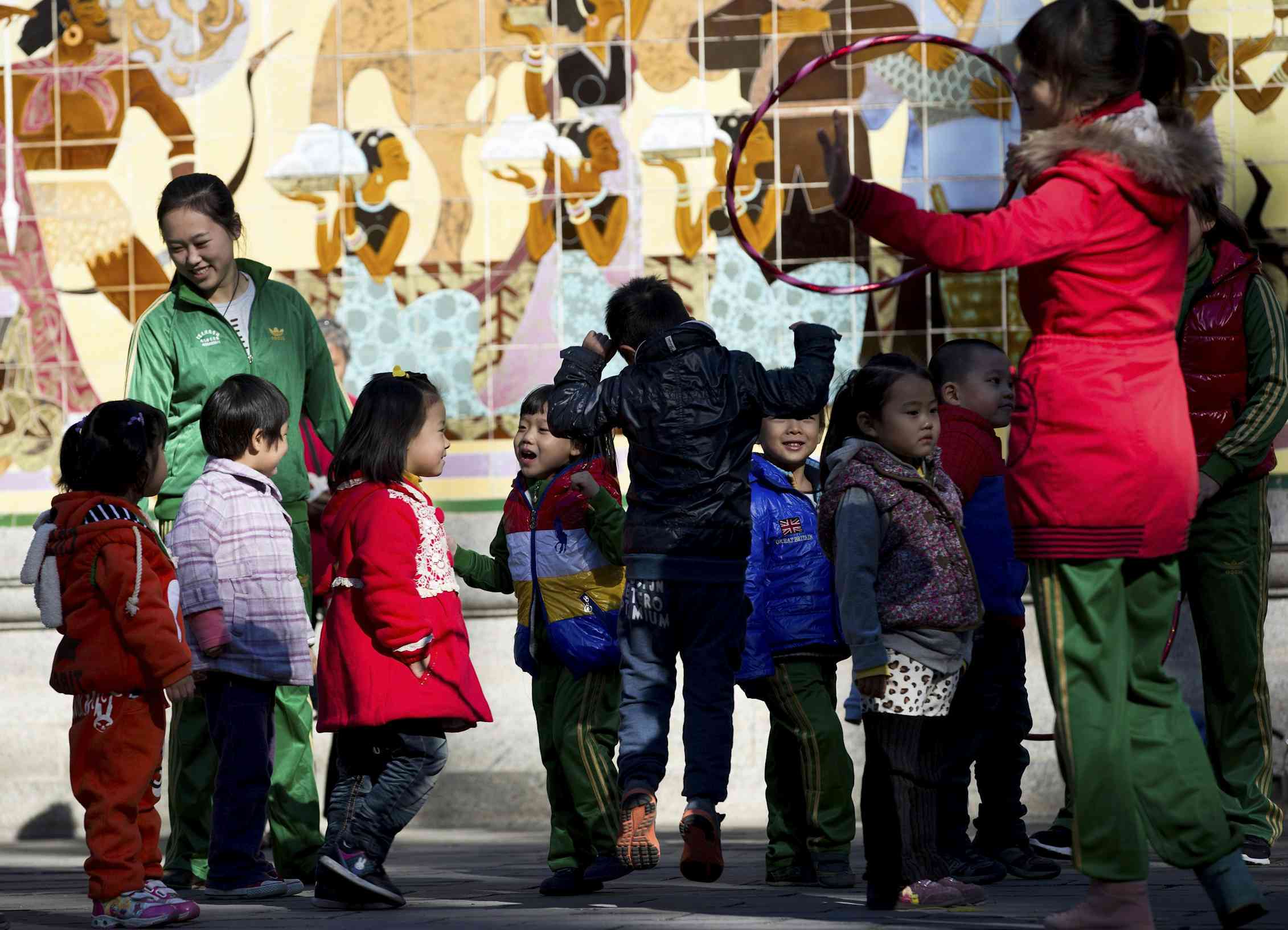 A teacher and students outdoors.