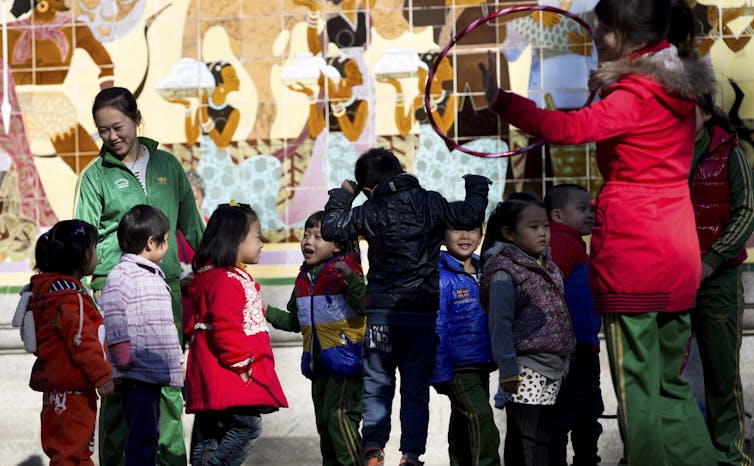 A teacher and students outdoors.