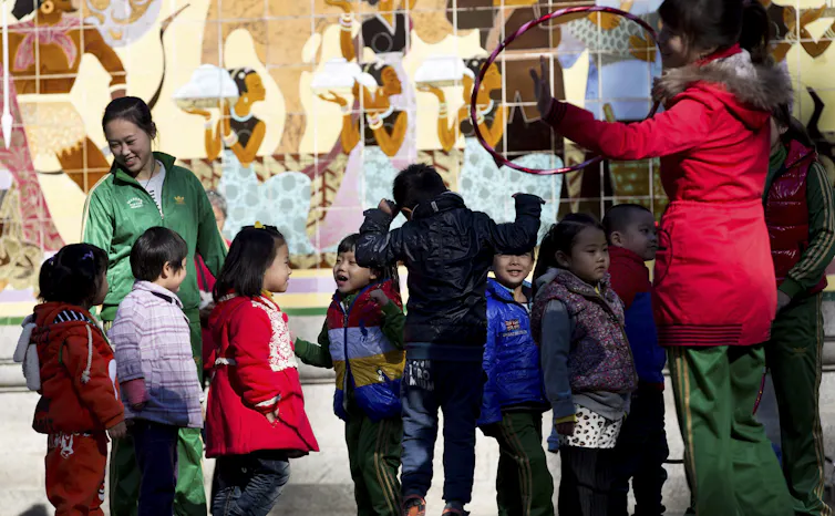 A teacher and students outdoors.