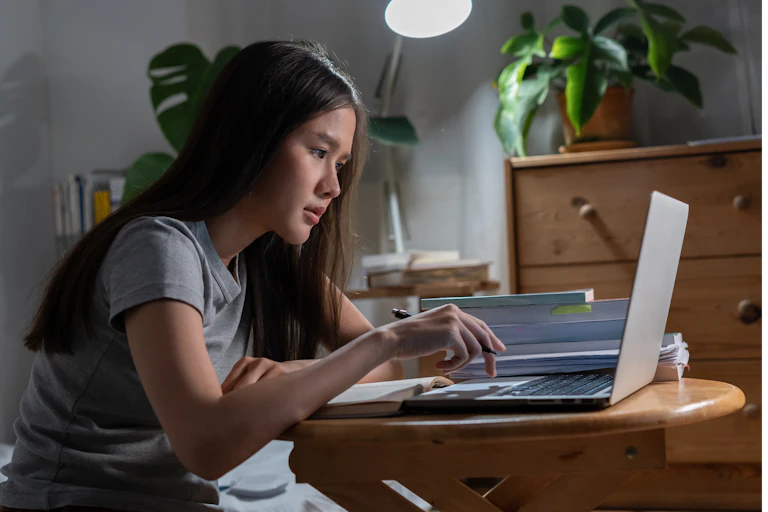 A student sitting at her laptop.