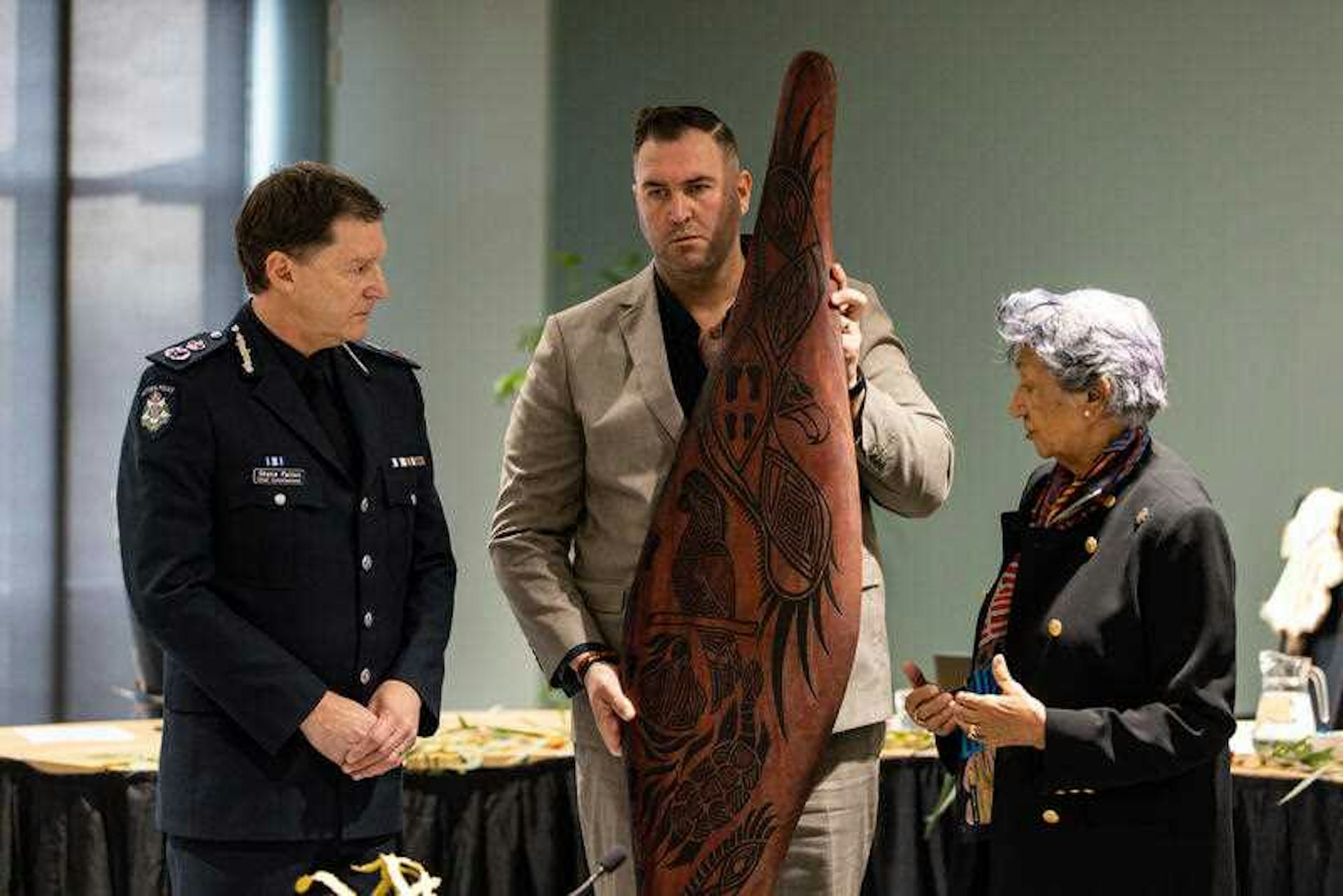 Victoria Police Chief Commissioner Shane Patton receives a shield from the members of the Yoorrook Justice Commission.