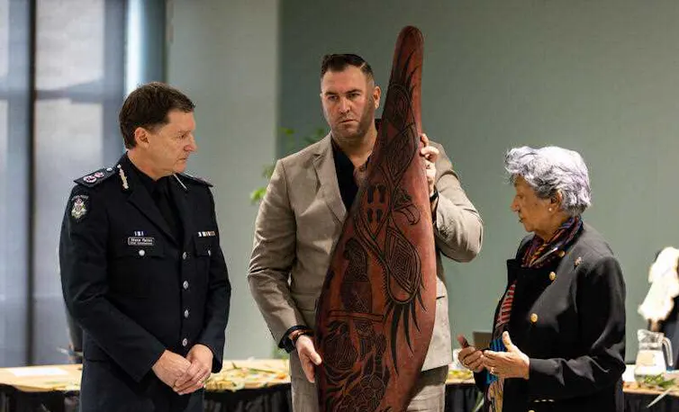 Victoria Police Chief Commissioner Shane Patton receives a shield from the members of the Yoorrook Justice Commission.