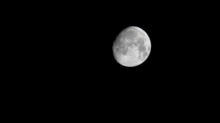A photo of a gibbous moon on a black background