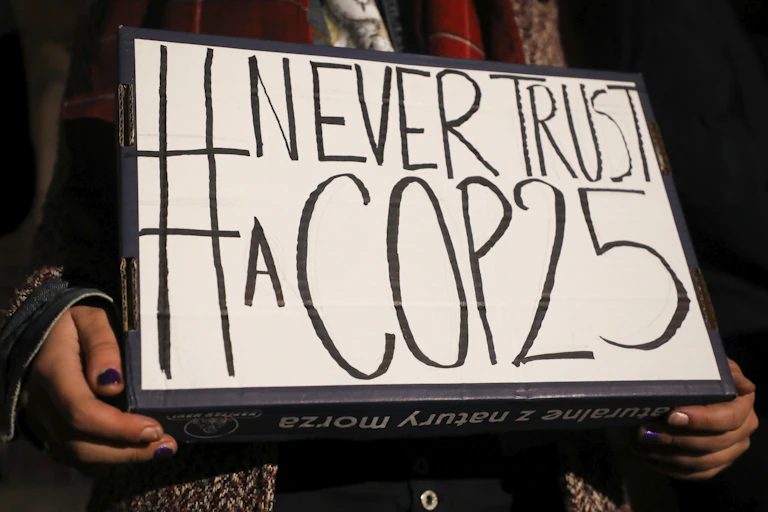 'NeverTrust a COP25' banner is hold during Global Climate Strike at the Main Square in Krakow, Poland on 13 December, 2019.