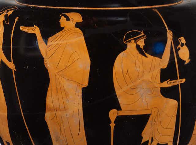 An ancient Greek vase picturing a scene of every day life. A man and a woman stand with their backs to each other, receiving food.