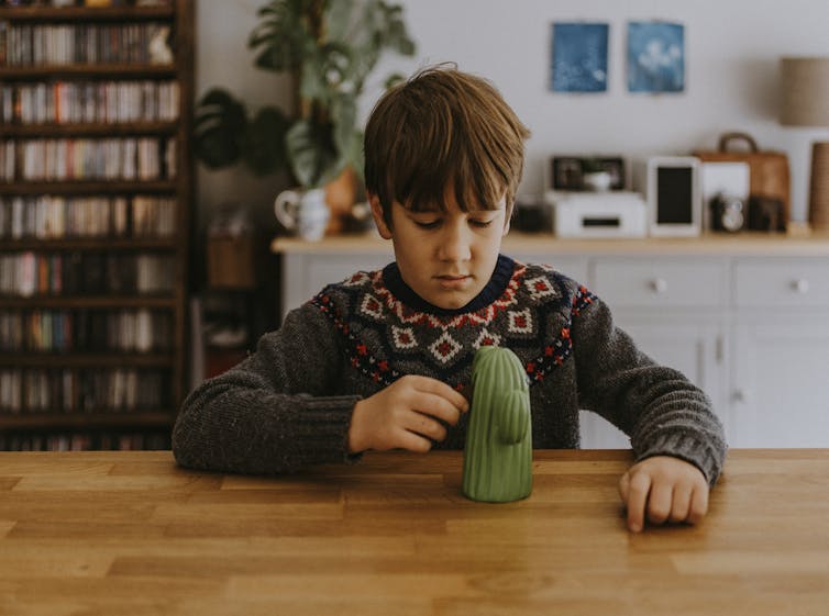 Worried boy looks at a cactus