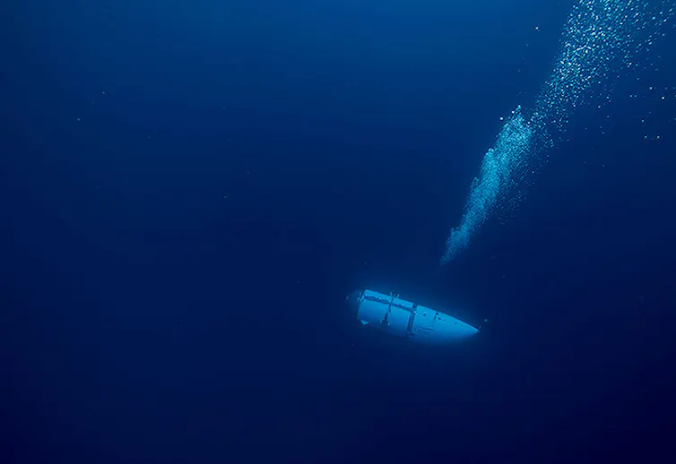 A dark blue image with a tube like shape floating in the lower third