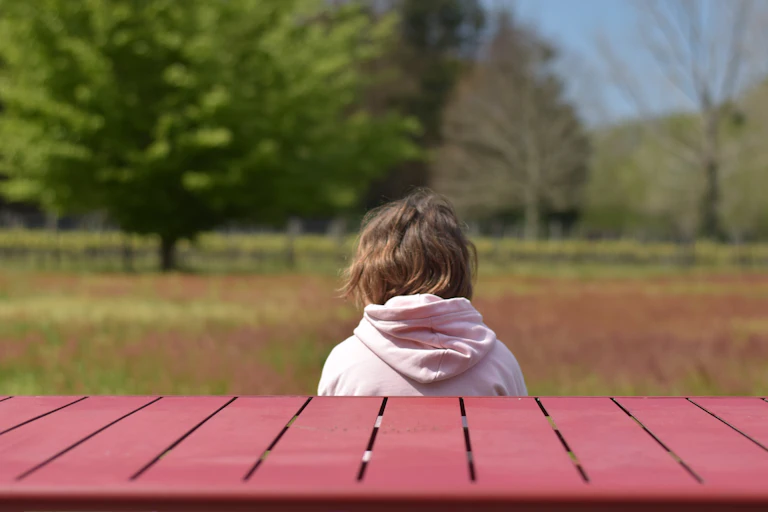Anxious child sits on a bench