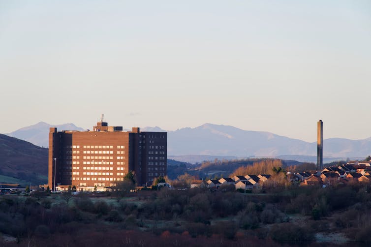View of hospital building with hills in the distance