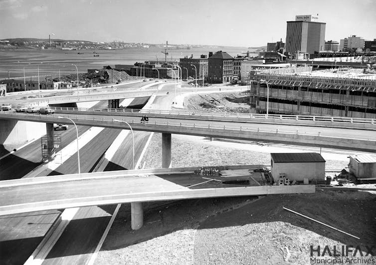 A black and white photo of a highway with overpasses