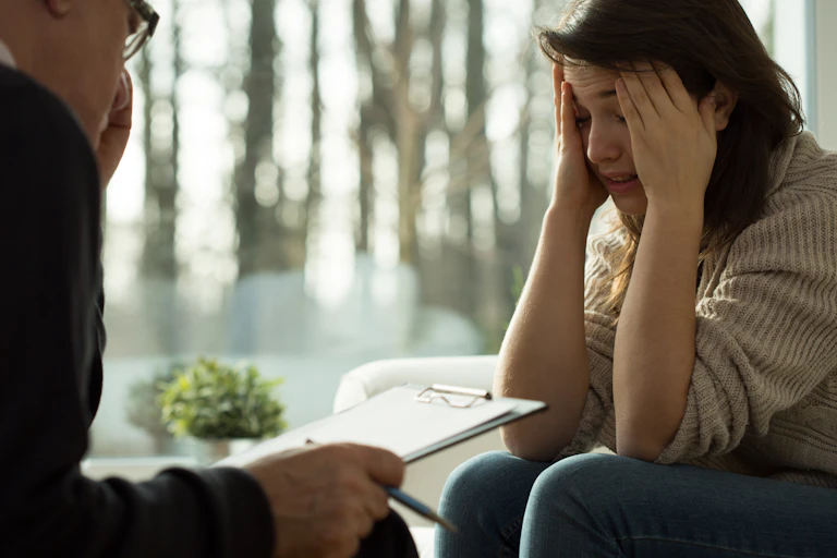 distressed young woman talks to man with clipboard