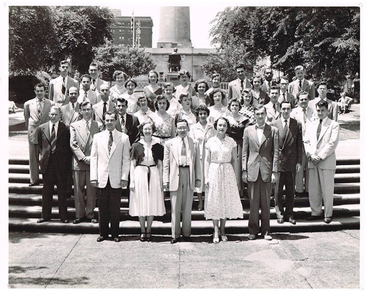 One black student stands with a group of white classmates.