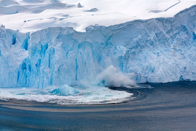 A glacier calving large chunks of ice.